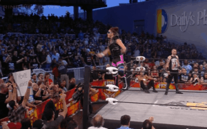 Fan Brings WWE Related Sign To AEW Fight For The Fallen