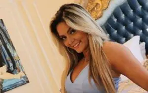 Tay Conti Rolls In Bed Wearing Low-Cut Dress