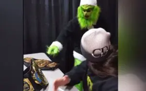 Grayson Waller Tries to Steal WWE Titles Dressed as the Grinch