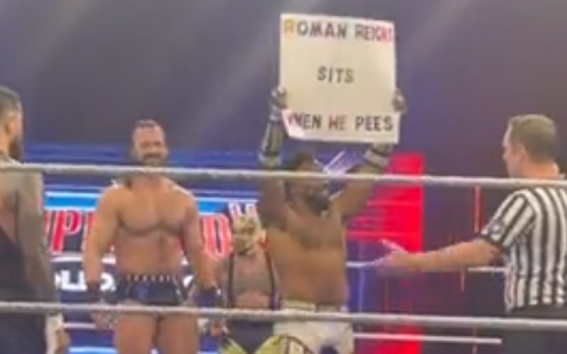 Roman Reigns Reacts To Fan Sign Saying He Sits When He Pees