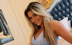 Tay Conti Rolls In Bed Wearing Low-Cut Dress