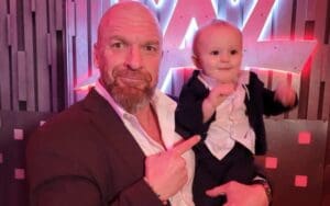 Triple H Takes Signature Point Photo With Johnny Gargano & Candice LeRae's Son Quill