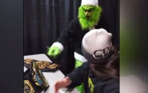 Grayson Waller Tries to Steal WWE Titles Dressed as the Grinch