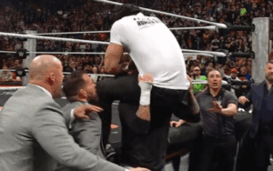 CM Punk Powerbombs Roman Reigns Through Announce Table During 3/30 WWE RAW